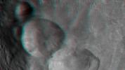 This anaglyph shows the topography of Vesta's 'Snowman' craters on asteroid Vesta. The bottom crater is named Marcia, the middle crater, Calpurnia, and the top crater, Minucia. You need 3-D glasses to view this image.