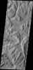 This image captured by NASA's 2001 Mars Odyssey spacecraft shows part of Sulci Gordii, a complexly fractured region east of Olympus Mons.