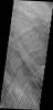 This image captured by NASA's 2001 Mars Odyssey spacecraft shows a series of low, concentric ridges is located to the west of Arsia Mons. The origin of these features is unknown, and there are no similar features at the other Tharsis volcanoes.