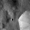 This image from NASA's Dawn spacecraft shows a sharp, fresh crater rim of a large crater that is only partly in the bottom right corner of this image and is located in Vesta's Numisia quadrangle, near asteroid Vesta's equator.