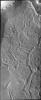 The dissected appearing surface in this image captured by NASA's Mars Odyssey spacecraft is called Hyperboreus Labyrinthus, located just south of Mars' north polar cap. The linear depressions are most likely caused by tectonic stress.