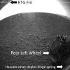 This labeled version of one of the first images taken by a rear Hazard-Avoidance camera on NASA's Curiosity rover shows a fin on the radioisotope thermoelectric generator, the rear left wheel and a spring that released the dust cover.