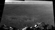 These are the first two full-resolution images of the Martian surface from the Navigation cameras on NASA's Curiosity rover, which are located on the rover's 'head' or mast. The rim of Gale Crater can be seen in the distance beyond the pebbly ground.