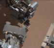 This image from NASA's Curiosity shows a scoop full of sand and dust lifted by the rover's first use of the scoop on its robotic arm. In the foreground, near bottom of this image, the bright object visible on the ground might be a piece of rover hardware.