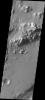 This image captured by NASA's 2001 Mars Odyssey spacecraft contains the landing site in the bottom right portion of the image, near the dark dunes. Note the channel that cuts through the crater rim on the left side of the image.