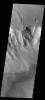 This image captured by NASA's 2001 Mars Odyssey spacecraft shows the western margin of Juventae Chasma and the dunes that occur at the base of the chasma cliff.