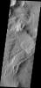 NASA's 2001 Mars Odyssey spacecraft shows the apparent effects of wind and water mark the surface of this region just northeast of Gusev Crater.