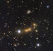 In this Hubble observation, astronomers used the massive galaxy cluster MACS J0647+7015 as the giant cosmic telescope. The bright yellow galaxies near the center of the image are cluster members.