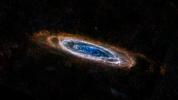 The ring-like swirls of dust filling the Andromeda galaxy stand out colorfully in this new image from the Herschel Space Observatory.