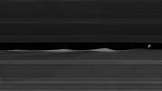 Daphnis, one of Saturn's ring-embedded moons, is featured in this view from NASA's Cassini spacecraft, kicking up waves as it orbits within the Keeler gap.