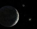 An artist's concept of the dwarf planet Eris and its moon Dysnomia. The sun is the small star in the distance.