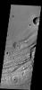 This image shows another portion of Ravi Vallis. In this image taken by NASA's 2001 Mars Odyssey spacecraft, a small crater and the resistant material formed during the impact form a 'donut' on the floor of the valley.