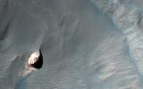 This observation captured by NASA's Mars Reconnaissance Orbiter shows a small crater in within the much larger Pollack Crater containing light-toned material.
