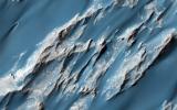 This image captured by NASA's Mars Reconnaissance Orbiter is of an ancient, approximately 3 billion year-old landslide shows two distinct surface albedos, which are proportions of reflected light.