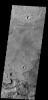 This image from NASA's 2001 Mars Odyssey spacecraft shows a portion of the floor of Antoniadi Crater. The faint, dark marks may be dust devil tracks.