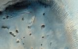 This fascinating observation from NASA's Mars Reconnaissance Orbiter shows us a dark-toned mound with pits inside an impact crater.