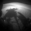 NASA's Mars Exploration Rover Opportunity caught its own silhouette in this late-afternoon image from the rover's rear HAZCAM on Mar, 20, 2014; its shadow falls across a slope called McClure-Beverlin Escarpment on the western rim of Endeavour Crater.