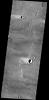 This image captured by NASA's 2001 Mars Odyssey spacecraft shows windstreaks on the volcanic surface between Alba Mons and Acheron Fossae.