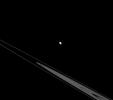 Although Epimetheus appears to be lurking above the rings here, it's actually just an illusion resulting from the viewing angle of NASA's Cassini spacecraft. In reality, Epimetheus and the rings both orbit in Saturn's equatorial plane.