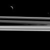 Two moons hover above the rings from this perspective, Enceladus (313 miles or 504 kilometers across), at left, and Janus (111 miles or 179 kilometers across), at right as seen by NASA's Cassini spacecraft.