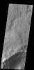 Dark slope streaks mark the rim of this unnamed crater in Terra Sabaea, as shown in this image captured by NASA's 2001 Mars Odyssey spacecraft.
