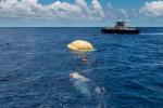 Hours after the June 28, 2014, test of NASA's Low-Density Supersonic Decelerator over the U.S. Navy's Pacific Missile Range, two members of the Navy's Explosive Ordinance Disposal swim toward the test vehicle.