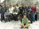 Robotics researchers at NASA's Jet Propulsion Laboratory in Pasadena, California, stand with robots RoboSimian and Surrogate, both built at JPL.