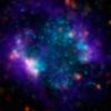 A small galaxy, called Sextans A, is shown here in a multi-wavelength mosaic captured by the ESA's Herschel mission. In this image, the purple shows gas; blue shows young stars and the orange and yellow dots are newly formed stars heating up dust.