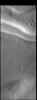 This image captured by NASA's 2001 Mars Odyssey spacecraft illustrates the complex surface of the polar cap, featuring not just different surface textures, but ridges and valleys as well.