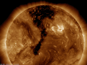 NASA's Solar Dynamics Observatory shows a long coronal hole has rotated so that was temporarily facing right towards Earth (Mar. 23-25, 2016). Coronal holes appear dark when viewed in some wavelengths of extreme ultraviolet light.