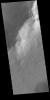This image captured by NASA's 2001 Mars Odyssey spacecraft shows downslope movement of material from the hill at the top of the image. Linear ridges and channels are visible on the surface to the debris flow deposit.