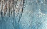Gullies are commonly found in the southern mid-latitudes of Mars. In this image from NASA's Mars Reconnaissance Orbiter they start near top of a long ridge, and descend into an impact crater that lies at the bottom of the ridge.