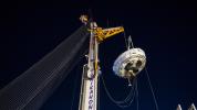 NASA's Low-Density Supersonic Decelerator hangs from a launch tower at U.S. Navy's Pacific Missile Range Facility in Kauai, Hawaii. The saucer-shaped vehicle will test two devices for landing heavy payloads on Mars.