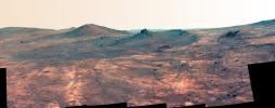 An elongated crater called 'Spirit of St. Louis,' with a rock spire in it, dominates this false-color image from the panoramic camera (Pancam) on NASA's Mars Exploration Rover Opportunity.