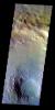 The THEMIS VIS camera contains 5 filters. Data from different filters can be combined in multiple ways to create a false color image. This image from NASA's 2001 Mars Odyssey spacecraft shows the central pit of an unnamed crater south of Coprates Catena.