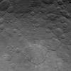 This image, taken by NASA's Dawn spacecraft on June 24, 2015, shows Dantu crater on dwarf planet Ceres from an altitude of 2,700 miles (4,400 kilometers); Dantu crater as small patches of bright material sprinkled around it.