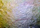 Unusual arc-shaped, reddish streaks cut across the surface of Saturn's ice-rich moon Tethys in this enhanced-color mosaic from NASA's Cassini spacecraft.