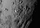 This close-up image from NASAs New Horizon spacecraft is of a region near Pluto equator reveals a giant surprise: a range of youthful mountains rising as high as 11,000 feet 3,500 meters above the surface of the icy body.