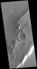 This image captured by NASA's 2001 Mars Odyssey spacecraft shows where an impact created a crater on top of a group of ridges called Tanaica Montes.