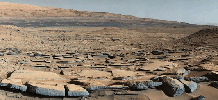 A view from the 'Kimberly' formation on Mars taken by NASA's Curiosity rover. The strata in the foreground dip towards the base of Mount Sharp, indicating the ancient depression that existed before the larger bulk of the mountain formed.