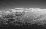 Just 15 minutes after its closest approach to Pluto on July 14, 2015, NASA's New Horizons spacecraft looked back toward the sun and captured a near-sunset view of the rugged, icy mountains and flat ice plains extending to Pluto's horizon.