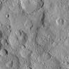 This image from NASA's Dawn spacecraft shows cratered terrain in the northern hemisphere of Ceres. Ikapati crater (top) appears with several flat plains filled by flows, smooth material and ejecta from the crater interior.