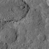 This view of Ezinu Crater on Ceres was taken by NASA's Dawn spacecraft on Oct. 19, 2015. Ezinu is the large crater in the top left corner of the image and contains a canyon-like feature near its center.