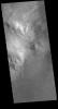 This image captured by NASA's 2001 Mars Odyssey spacecraft shows part of the central peak of Moreux Crater and the numerous sand dunes located on the crater floor.