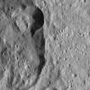 This view captured by NASA's Dawn spacecraft shows a section of Jarimba Crater on Ceres. A portion of the crater rim near top center appears much sharper, with smoother walls, than elsewhere.