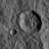 This image, taken by NASA's Dawn spacecraft on Jan. 1, 2016, shows two relatively young, fresh craters on Ceres. Large blocks of ejected material fell near the rims of the craters and onto the floor of the larger crater.