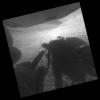 A shadow and wheel tracks of NASA's Mars Exploration Rover Opportunity appear in this image taken by a rear hazard avoidance camera (hazcam) just after a drive on a slope above Endeavour Crater on March 22, 2016.