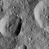 NASA's Dawn spacecraft took this image of unnamed craters in the northern hemisphere of Ceres. The crater at left displays rough spurs of compacted material along its lower edge, while the rest of its rim appears much smoother.