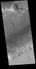 This image from NASA's 2001 Mars Odyssey spacecraft shows a small portion of Kasei Valles. The channel rim at the top of the image shows a complex series of processes.