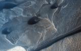 Mars' permanent North Polar cap is ringed by sand dunes. In the winter and spring the dunes are covered by a seasonal cap of dry ice as seen by NASA's by NASA's Mars Reconnaissance Orbiter spacecraft.